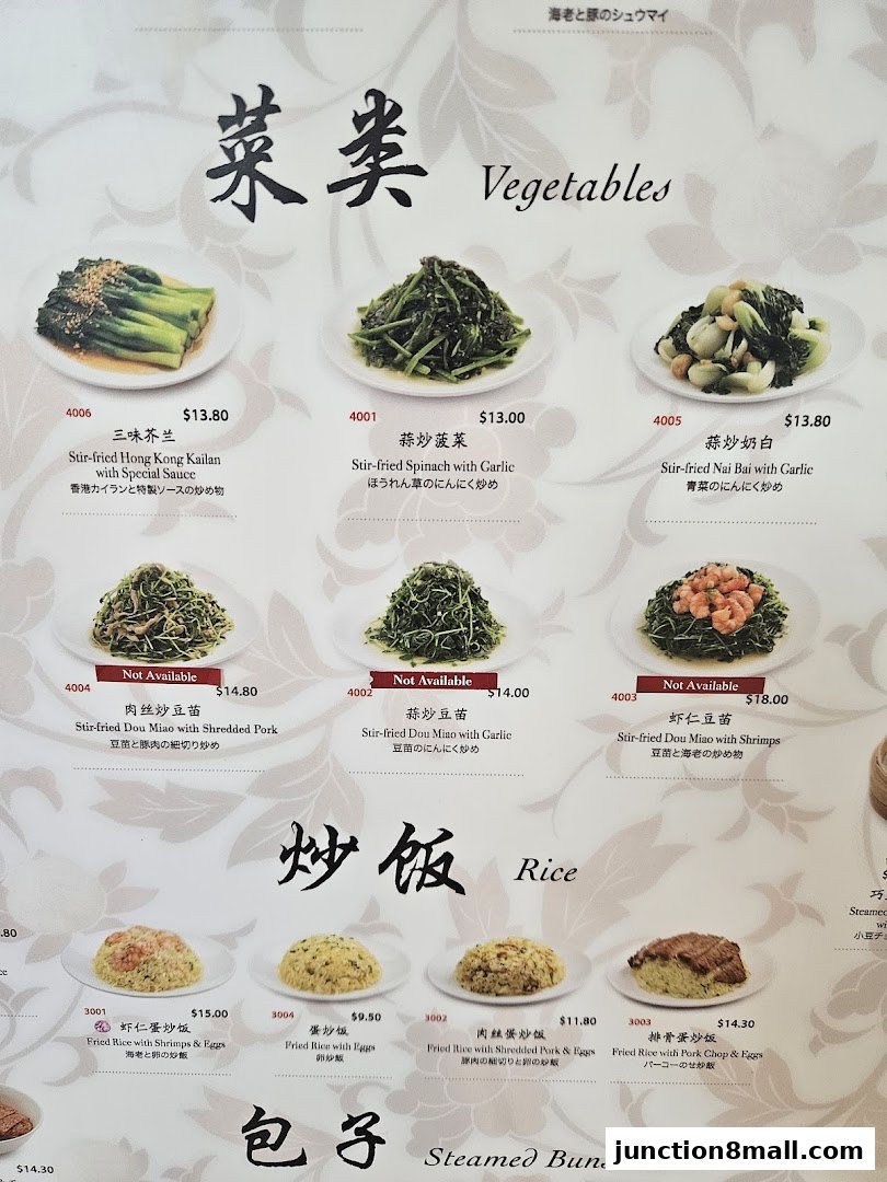 A menu page from Din Tai Fung featuring vegetables, rice dishes, and steamed buns with prices.