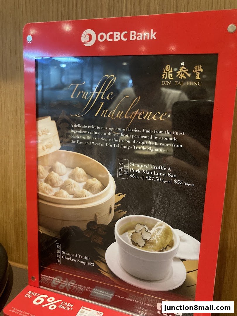 A menu board showcasing Din Tai Fung's truffle-infused dishes, including Xiao Long Bao and chicken soup.