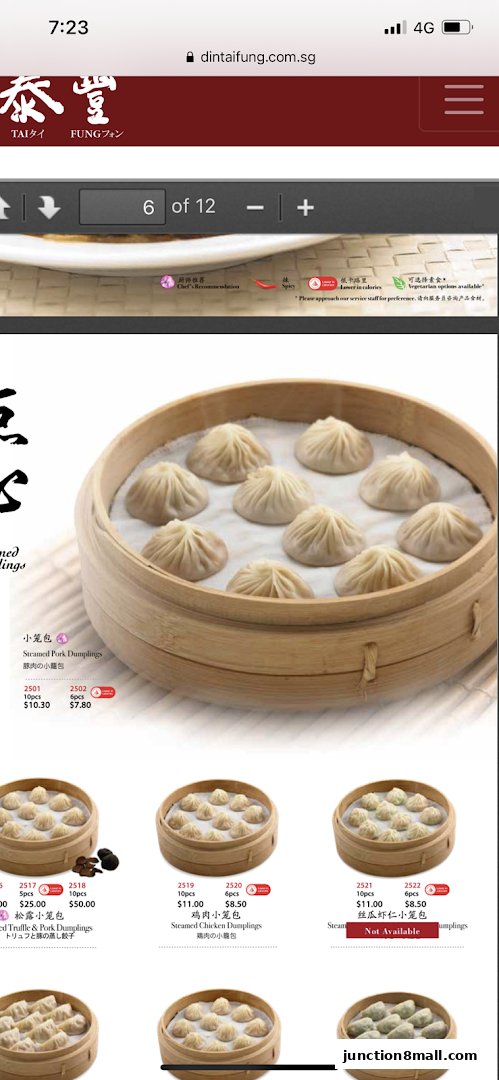 A close-up of steamed pork dumplings in bamboo steamers, with menu details visible.