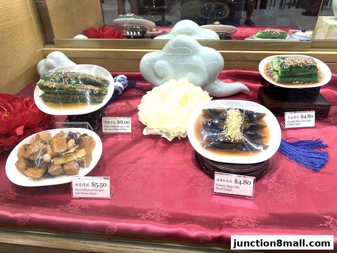 A display of various Chinese dishes, including stuffed peppers, beancurd cubes, and century eggs.