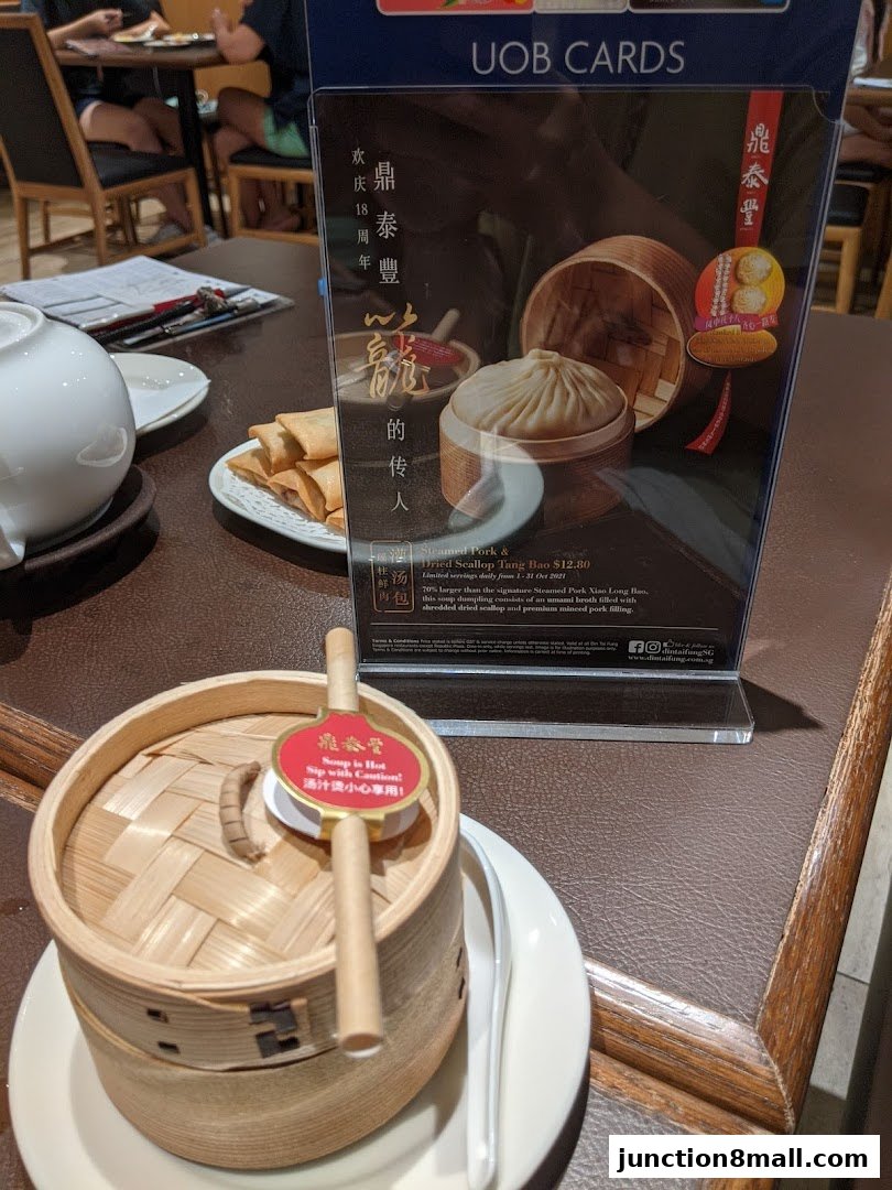 A close-up of a Steamed Pork & Dried Scallop Tang Bao at Din Tai Fung.