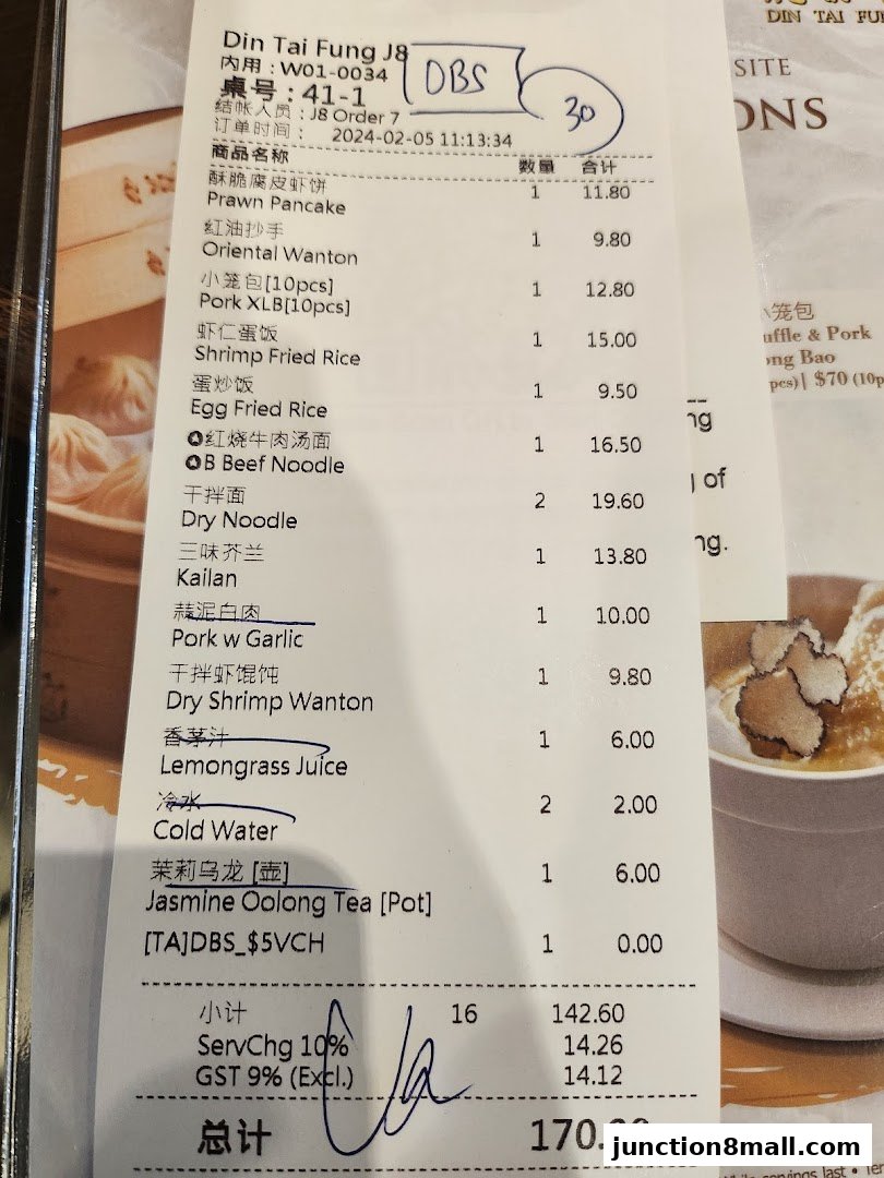 A receipt from Din Tai Fung Junction 8 listing various food and drink items with prices.