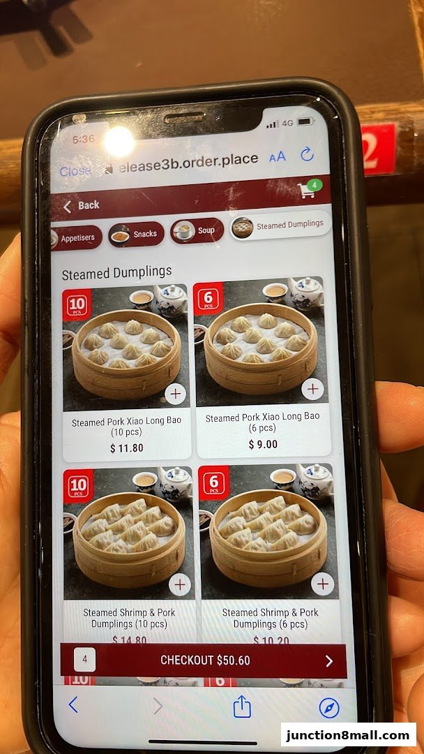 A smartphone screen displaying the Din Tai Fung menu with various steamed dumplings.