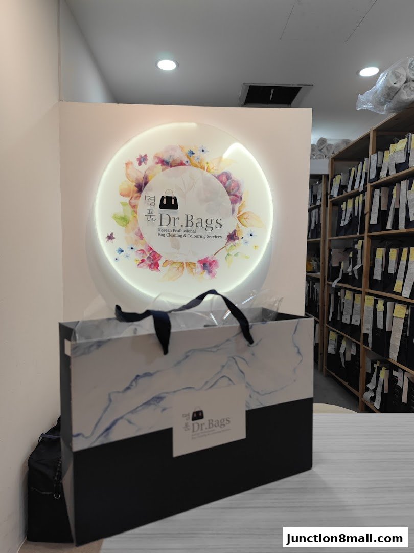 A shopping bag from Dr. Bags with a floral logo and shelves of items in the background.