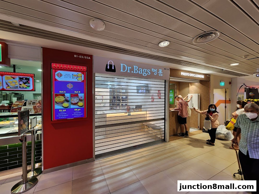 The exterior of Dr. Bags shop with a digital menu board displaying food sets.