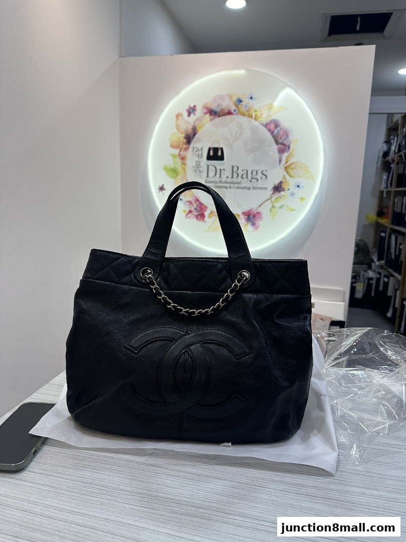 A black Chanel bag is displayed in front of a circular logo for Dr. Bags.