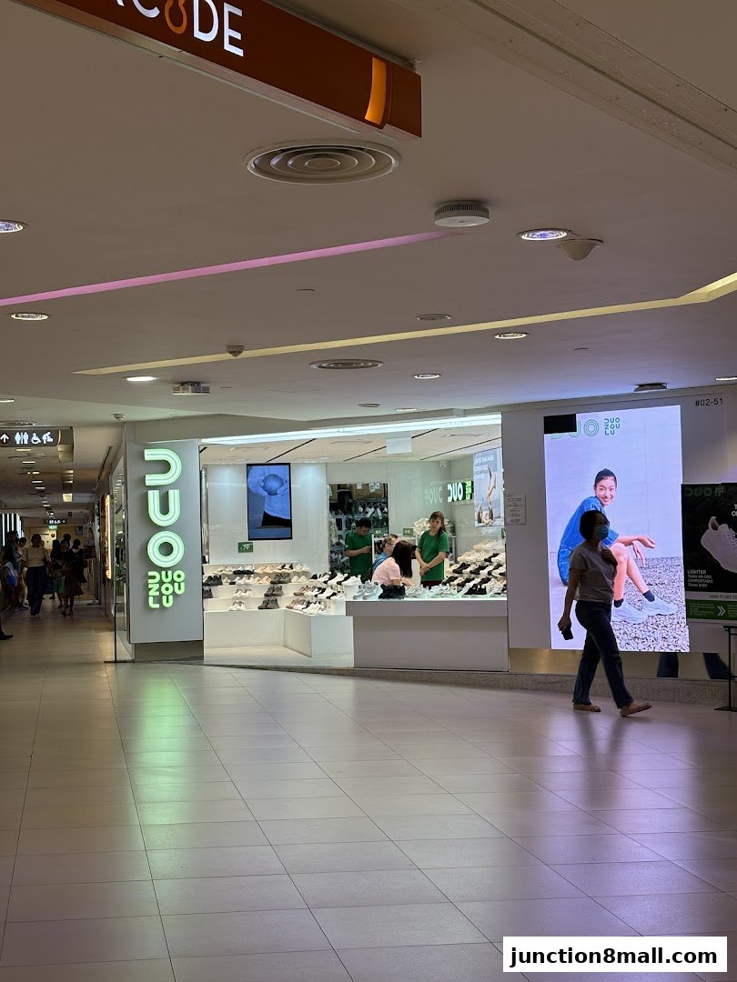 The DUOZOULU Junction 8 shop displays a variety of footwear in a well-lit mall setting.
