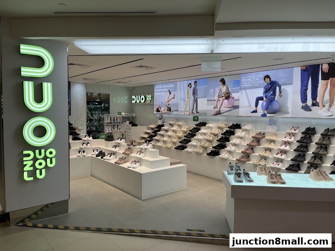 The entrance of a DUOZOULU shoe store showcasing a wide variety of sneakers displayed on tiered shelves.