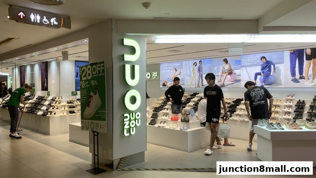 A shoe store with a display of various footwear and promotional signage.