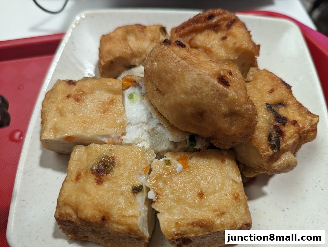 A plate of golden-brown fried tofu filled with white fish paste and vegetables.