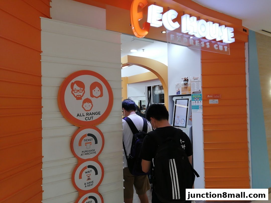 The entrance of EC House Express Cut, a hair salon, with signage and customers queuing.