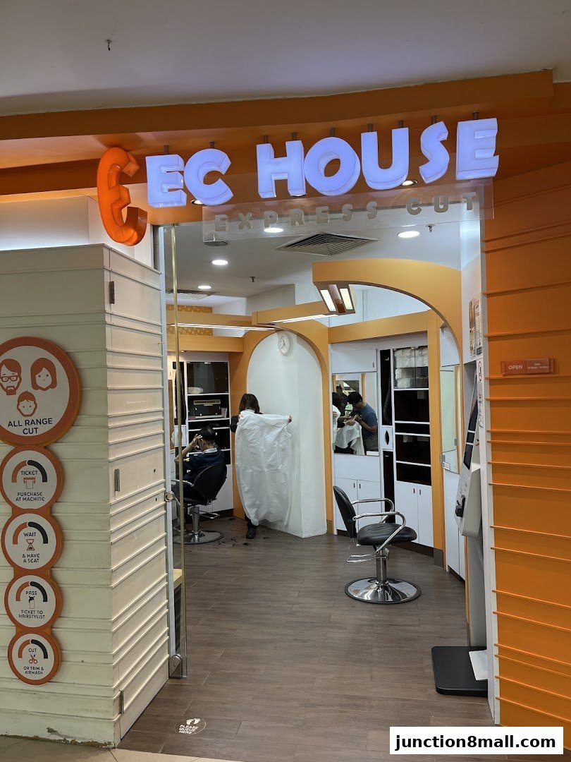 The entrance to EC House Express Cut, a hair salon with a bright orange exterior and interior.