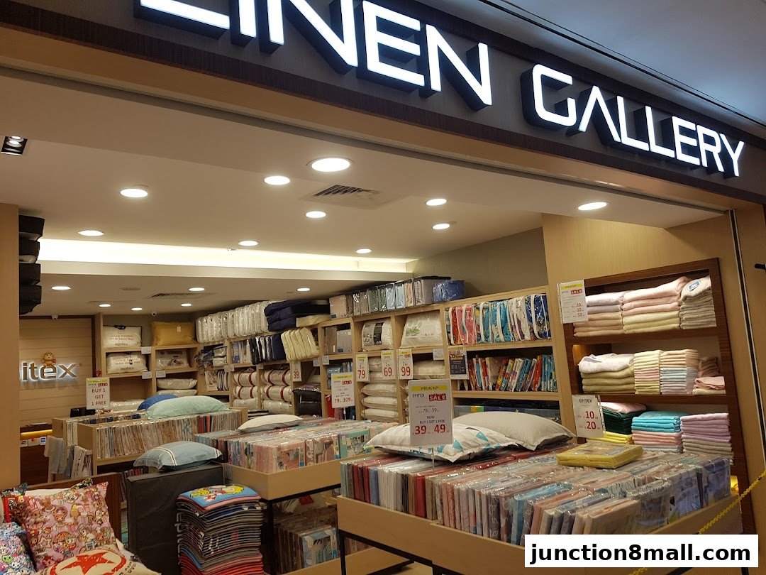 Interior view of Epitex Linen Gallery showcasing bedding and linens on shelves and displays.