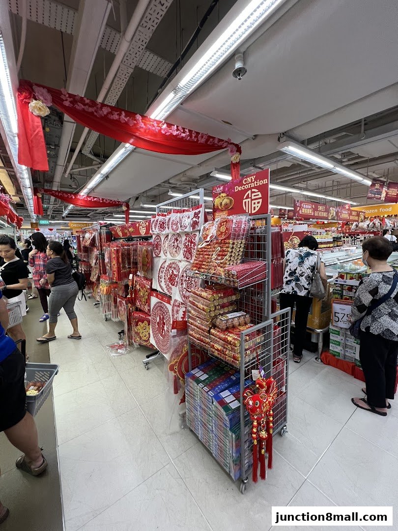 FairPrice Finest supermarket aisle decorated with red Chinese New Year decorations and merchandise.
