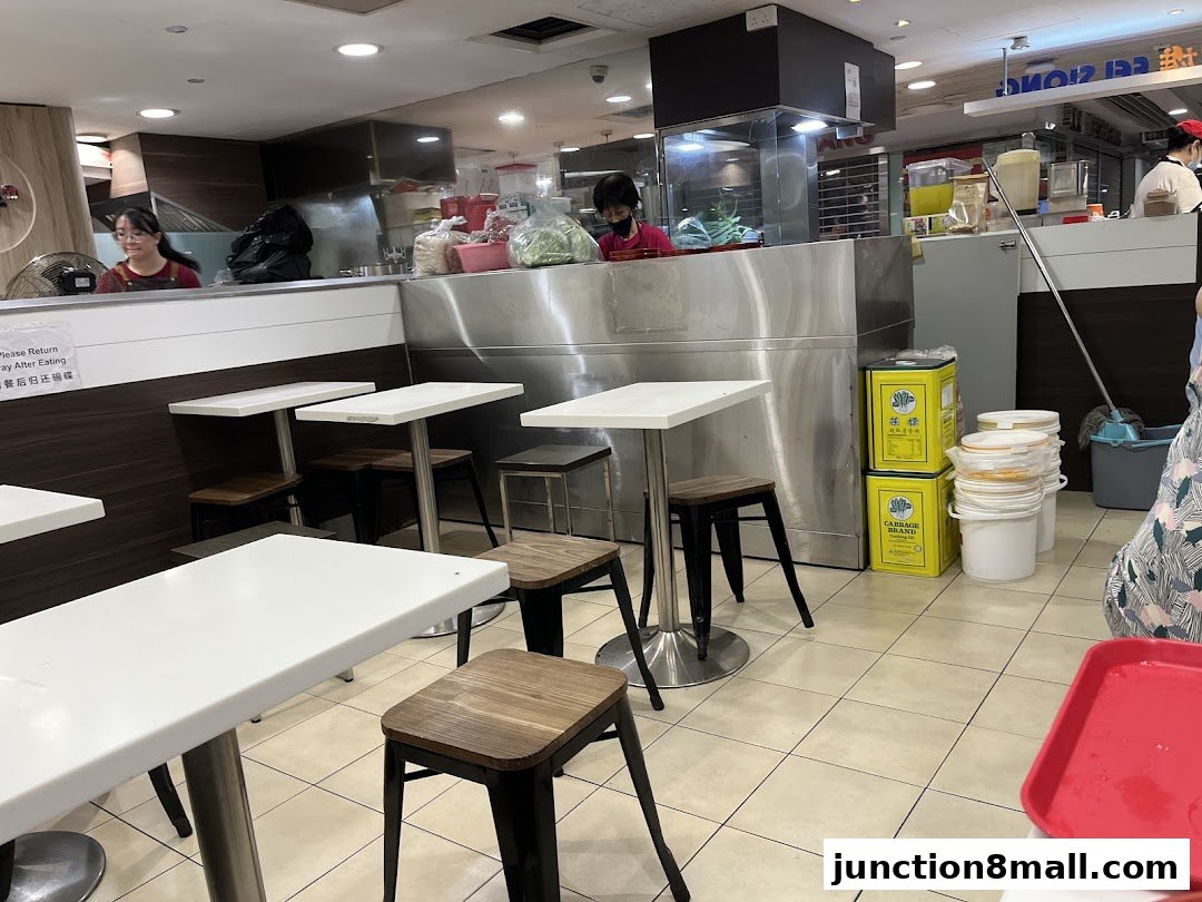 Interior view of a casual dining establishment with tables, chairs, and a service counter.
