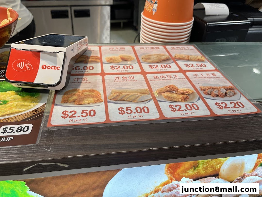 A menu display with various food items and prices, along with a payment terminal.