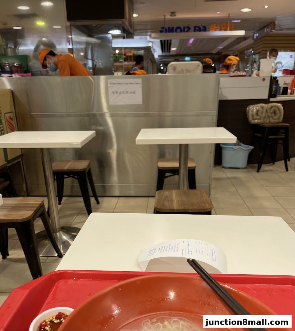 Interior view of a casual dining restaurant with tables, chairs, and staff working behind a counter.
