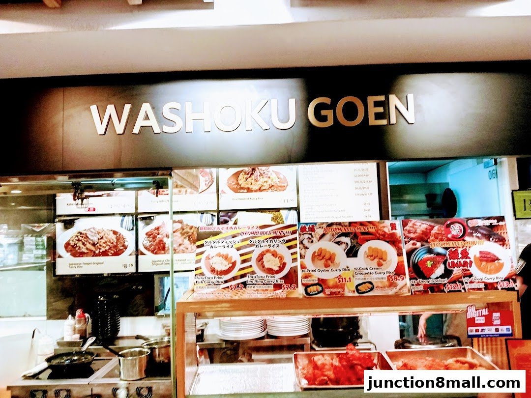 A food stall with a menu displaying Japanese curry dishes and other fried items.