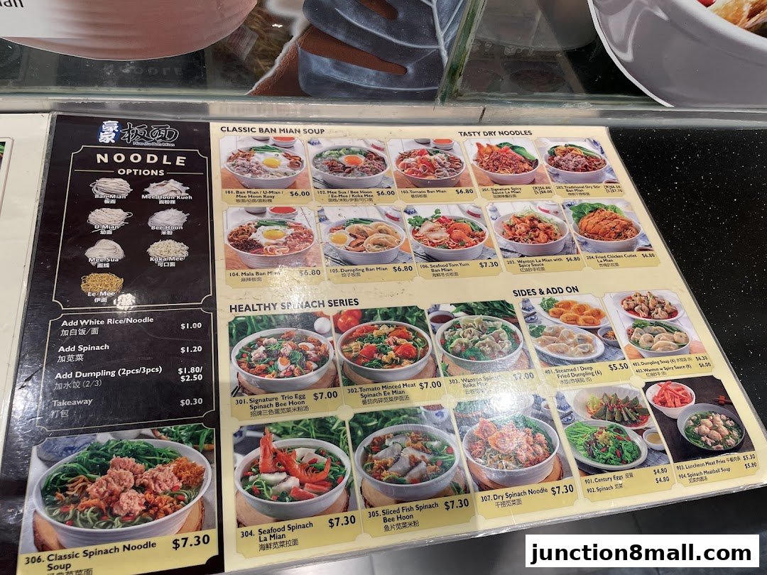 A menu display for Food Junction featuring various noodle dishes, sides, and add-ons with enticing food photography.