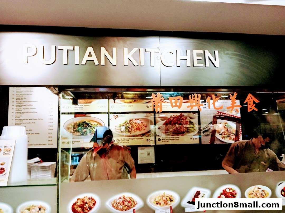 A view of the Putian Kitchen food stall with menu items and staff.