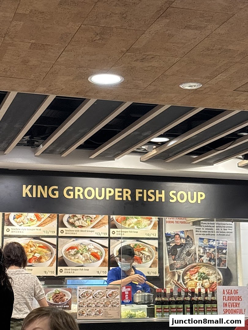A food stall displaying various king grouper fish soup dishes and prices.