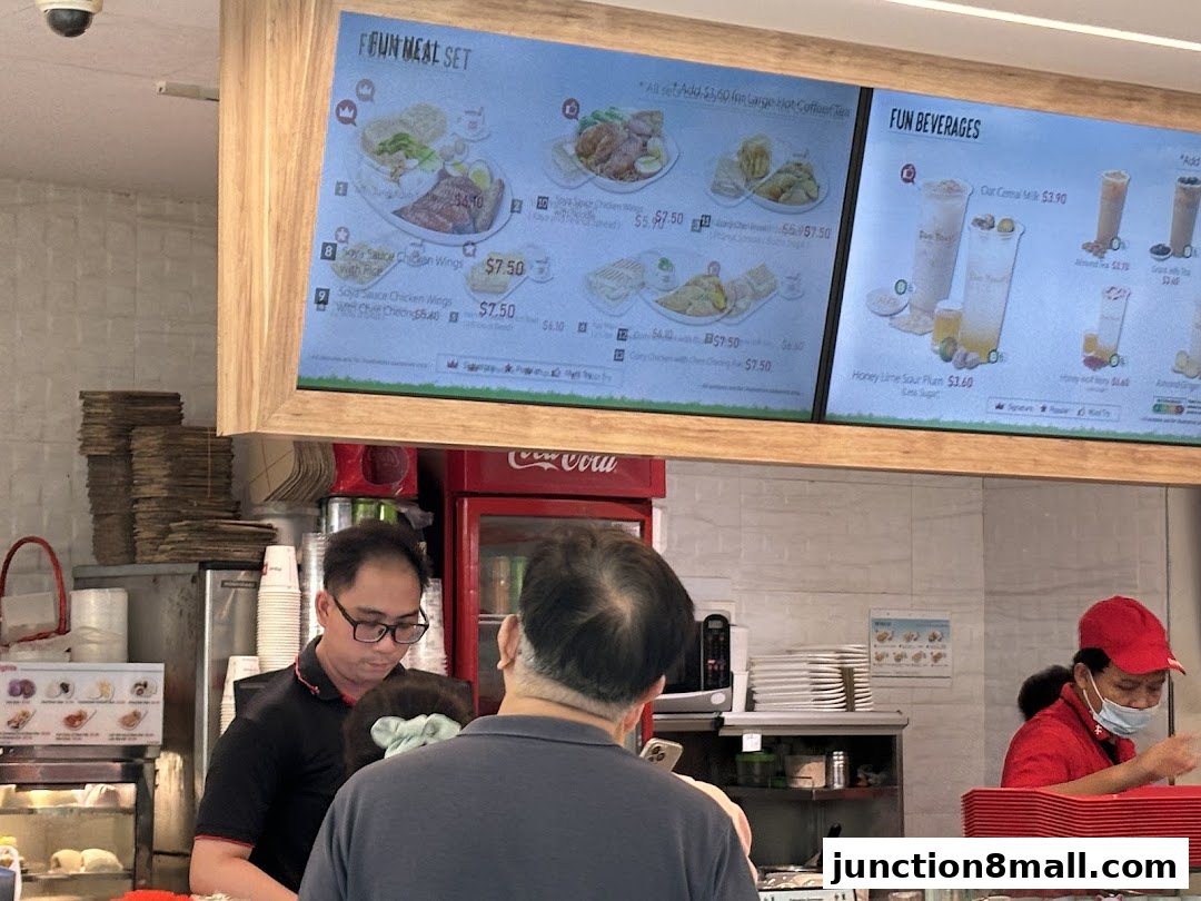 A digital menu board displaying meal sets and beverages at Fun Toast Junction 8.