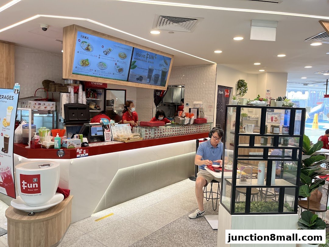 Interior view of a Fun Toast cafe with customers and staff at the counter.