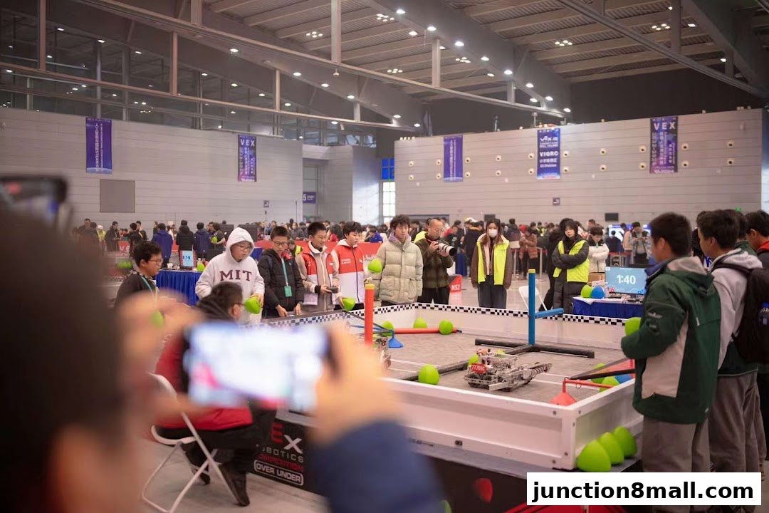 Students participate in a robotics competition with robots on a track.