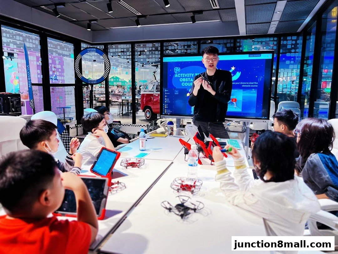 Children learning about drones in a classroom setting with an instructor.