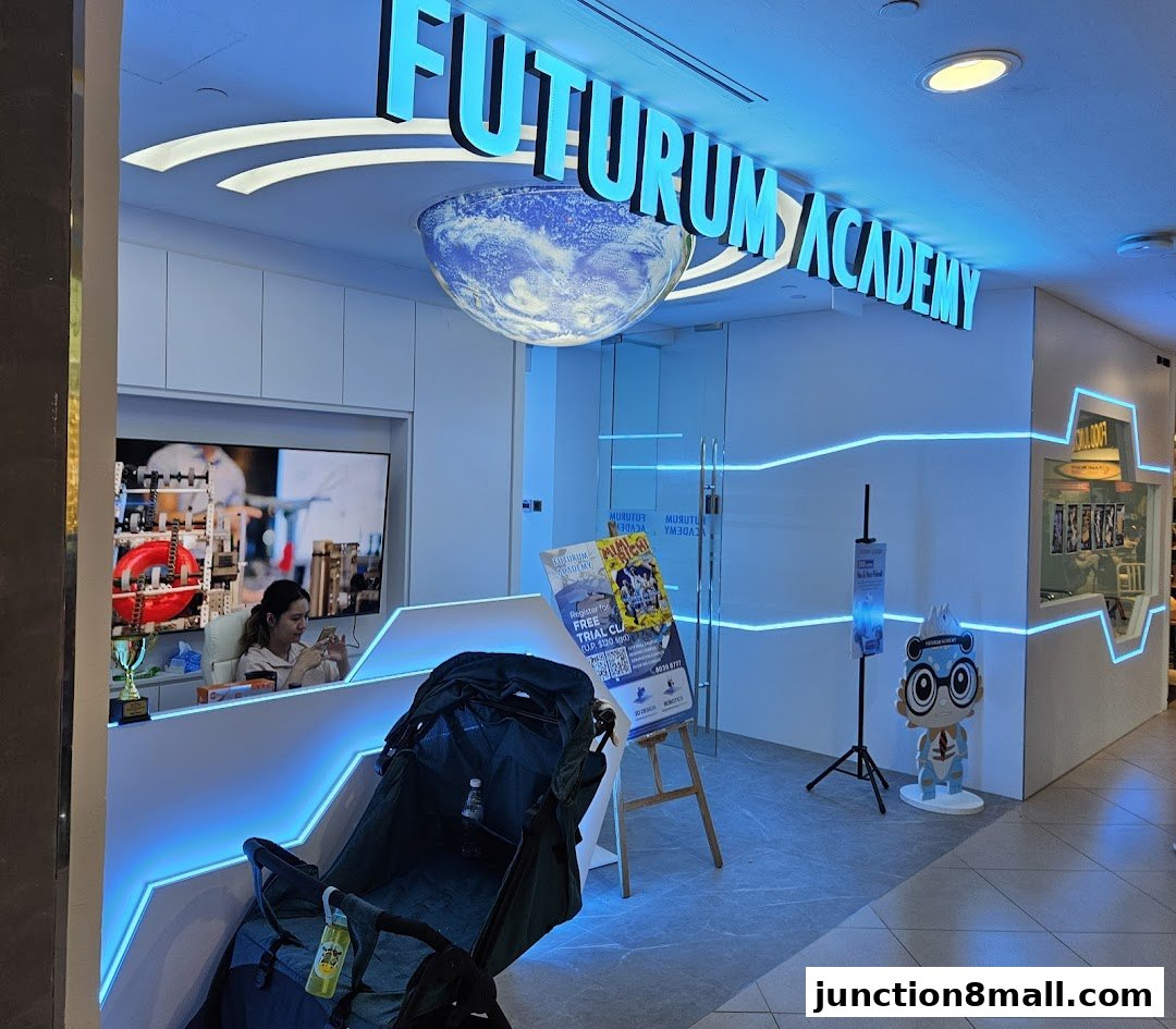 The entrance of Futurum Academy, a modern learning center with bright blue neon lights.