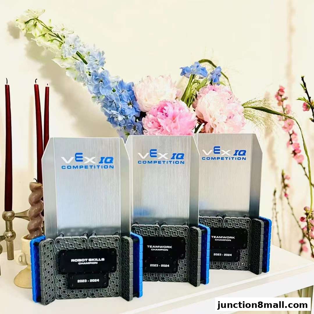 Three VEX IQ Competition trophies displayed with flowers and candles.