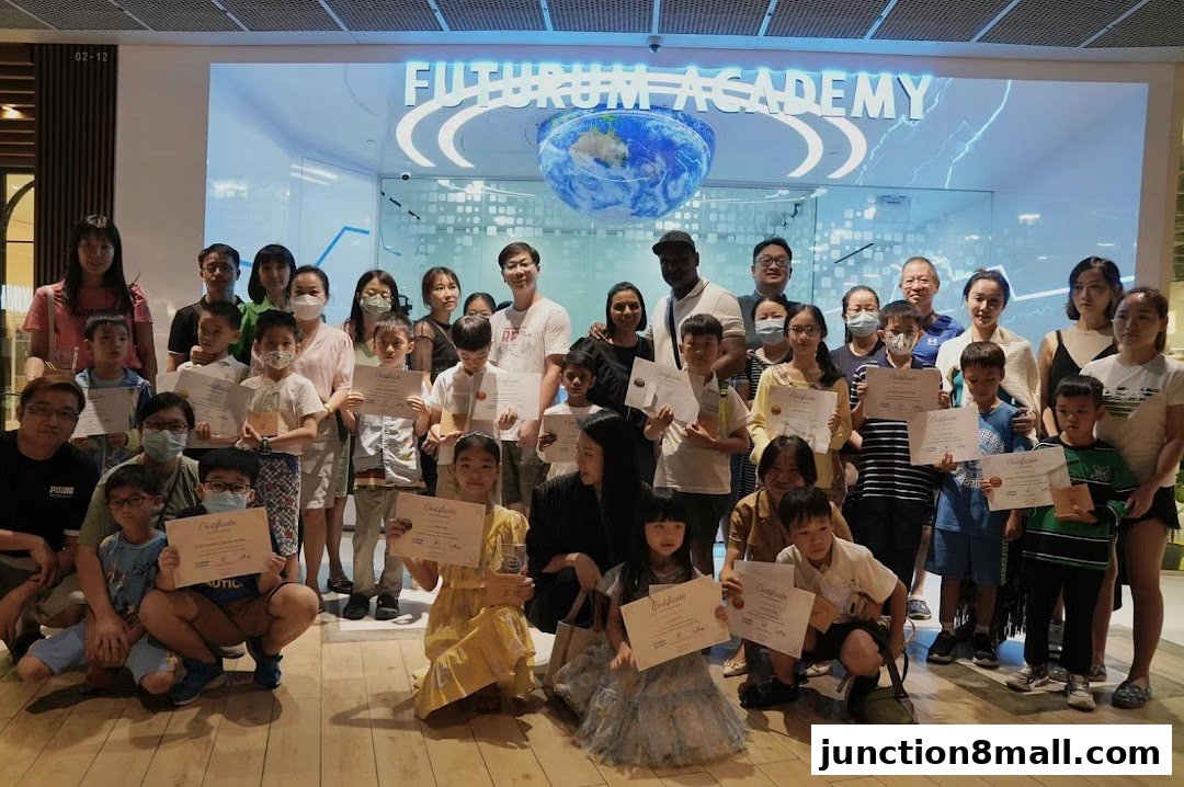 A group of students and adults pose for a photo in front of the Futurum Academy entrance.