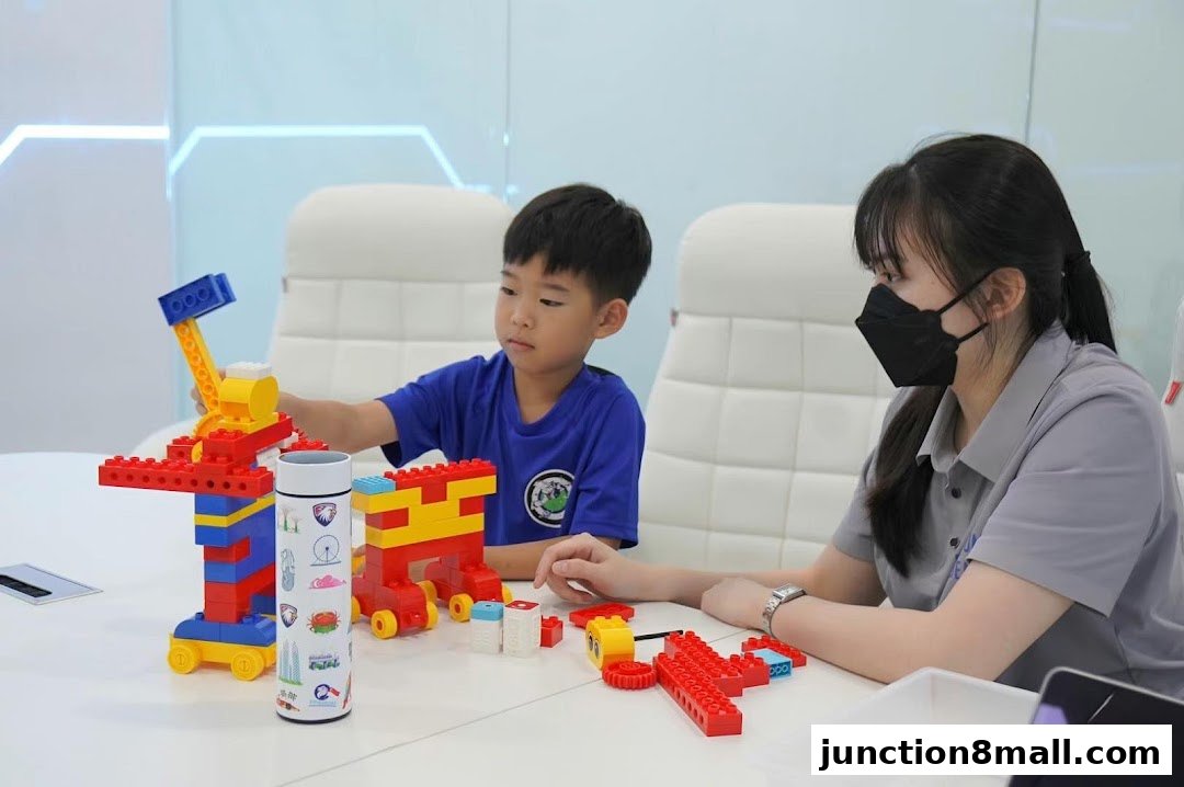 A young boy and an instructor build with colorful blocks at a table.