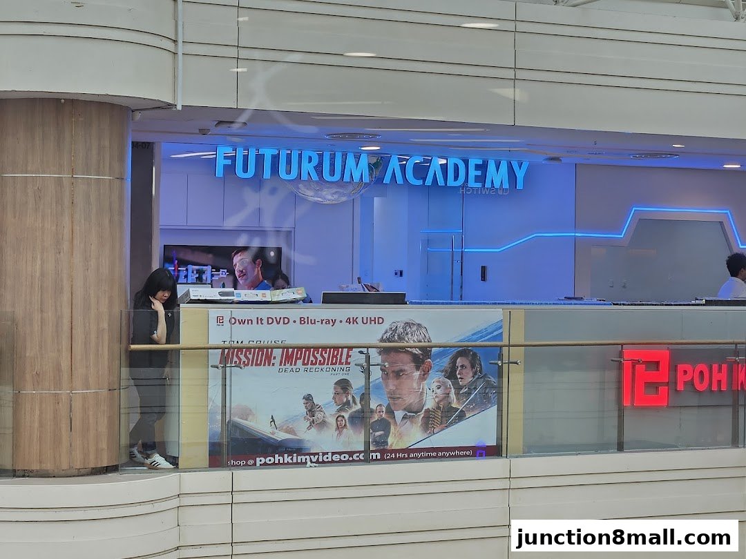 Futurum Academy shop front with a movie poster and a person looking down.