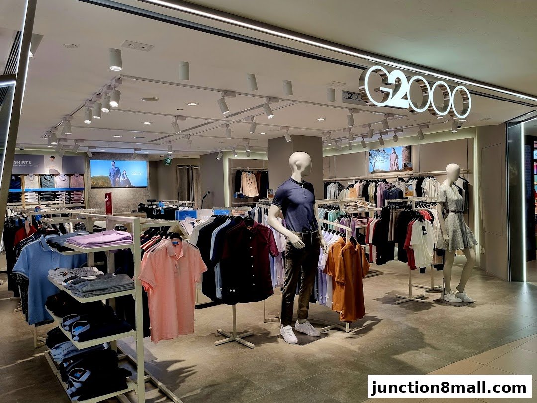 Interior view of a G2000 clothing store showcasing men's and women's apparel on racks and mannequins.