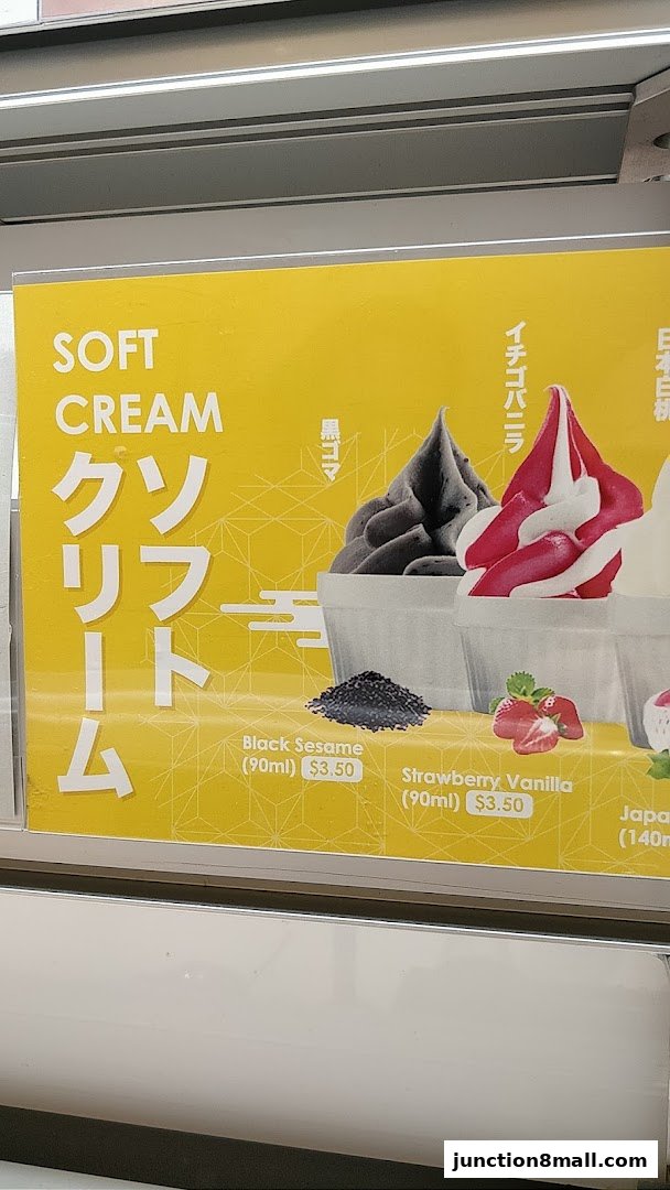 A sign advertising soft serve ice cream flavors including Black Sesame and Strawberry Vanilla.