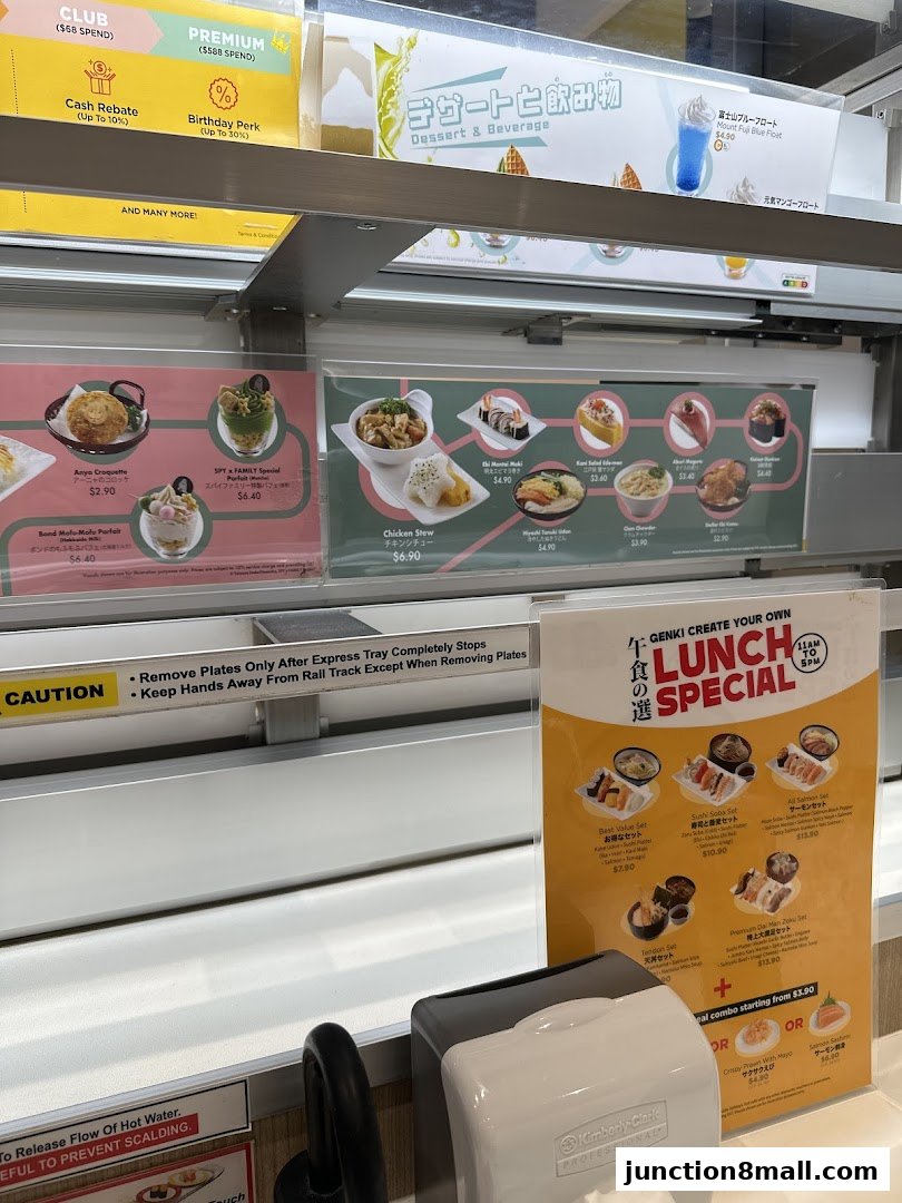 A display of various Japanese food items and drinks offered at Genki Sushi Junction 8.