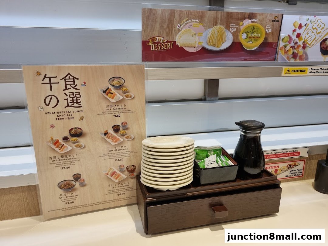 A menu board displays various lunch specials and desserts from Genki Sushi.