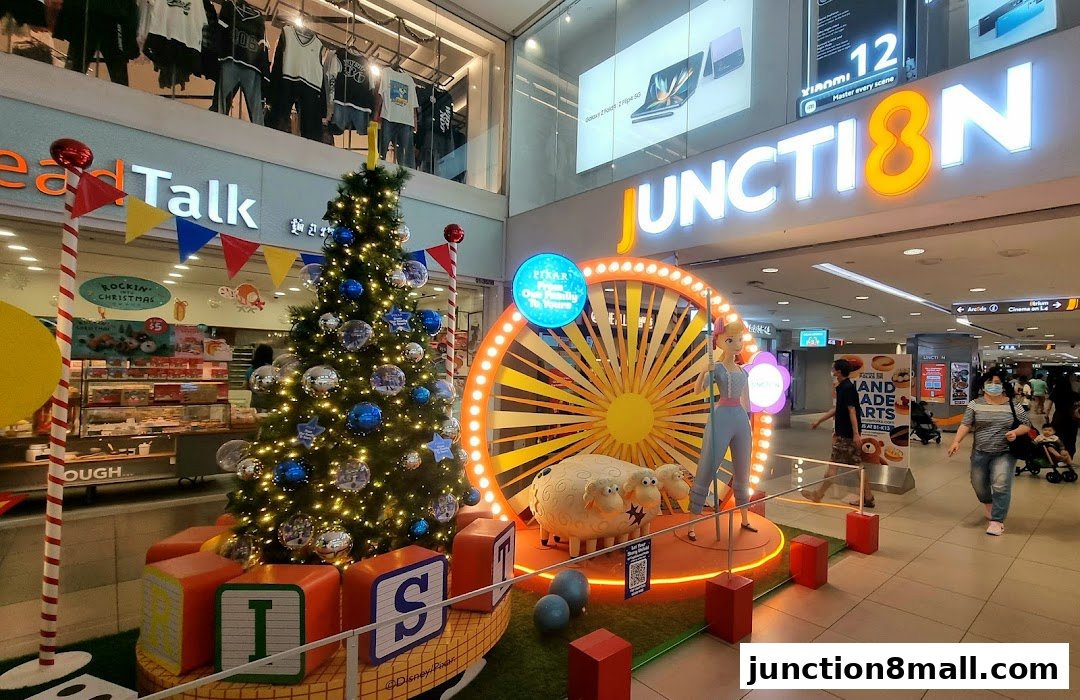 A festive Christmas display featuring a tree, Toy Story characters, and a large illuminated wheel.