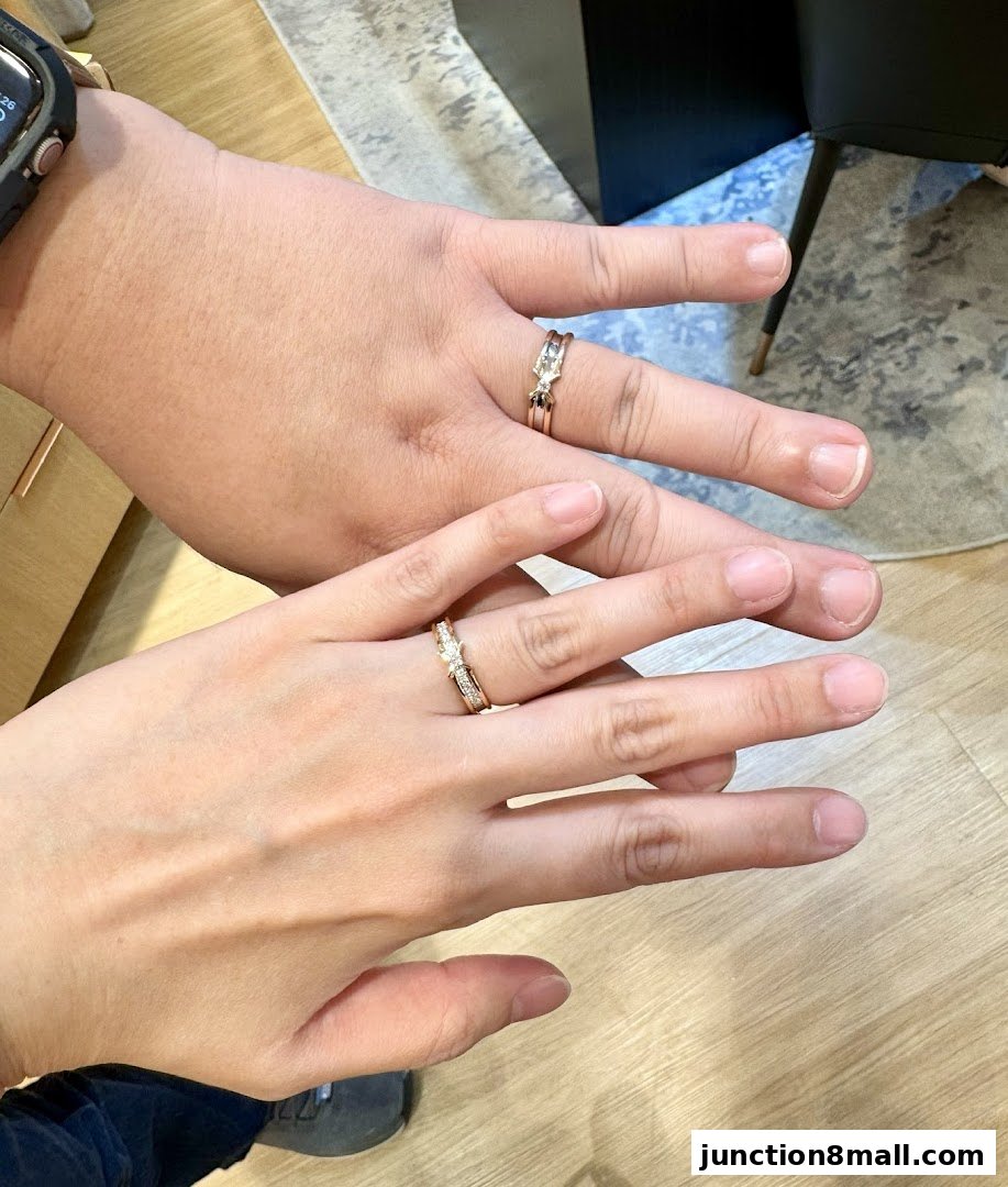 Close-up of two hands wearing elegant diamond rings, symbolizing commitment.