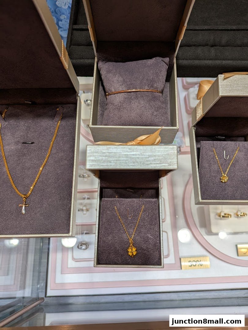 A display of elegant gold necklaces and a bracelet in open jewelry boxes.