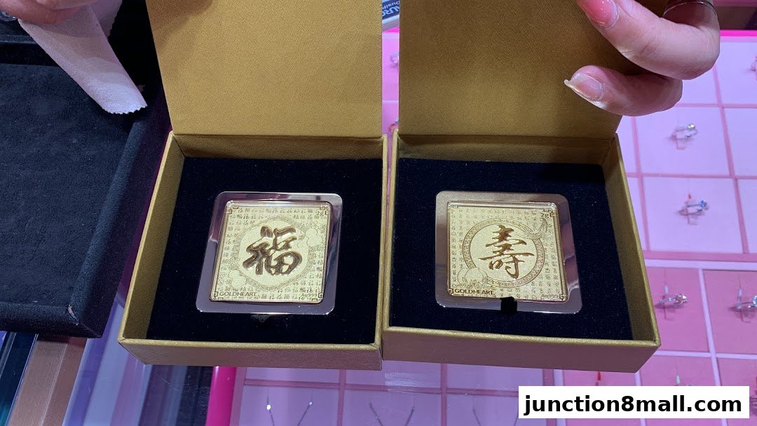 Two gold ingots with Chinese characters for fortune and longevity in gift boxes.
