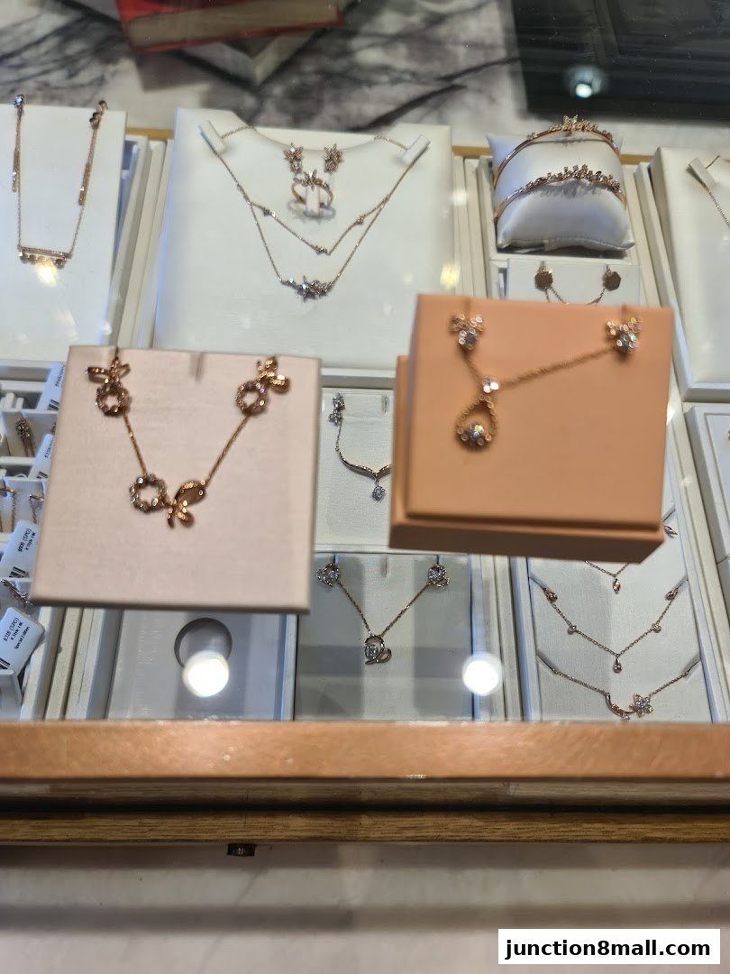 A display of elegant rose gold necklaces and earrings with intricate designs.