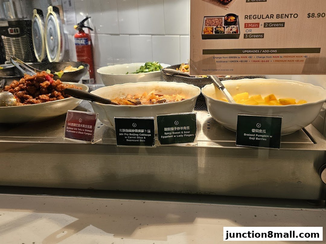 A display of various dishes offered at Greendot Junction 8, including bentos and side dishes.