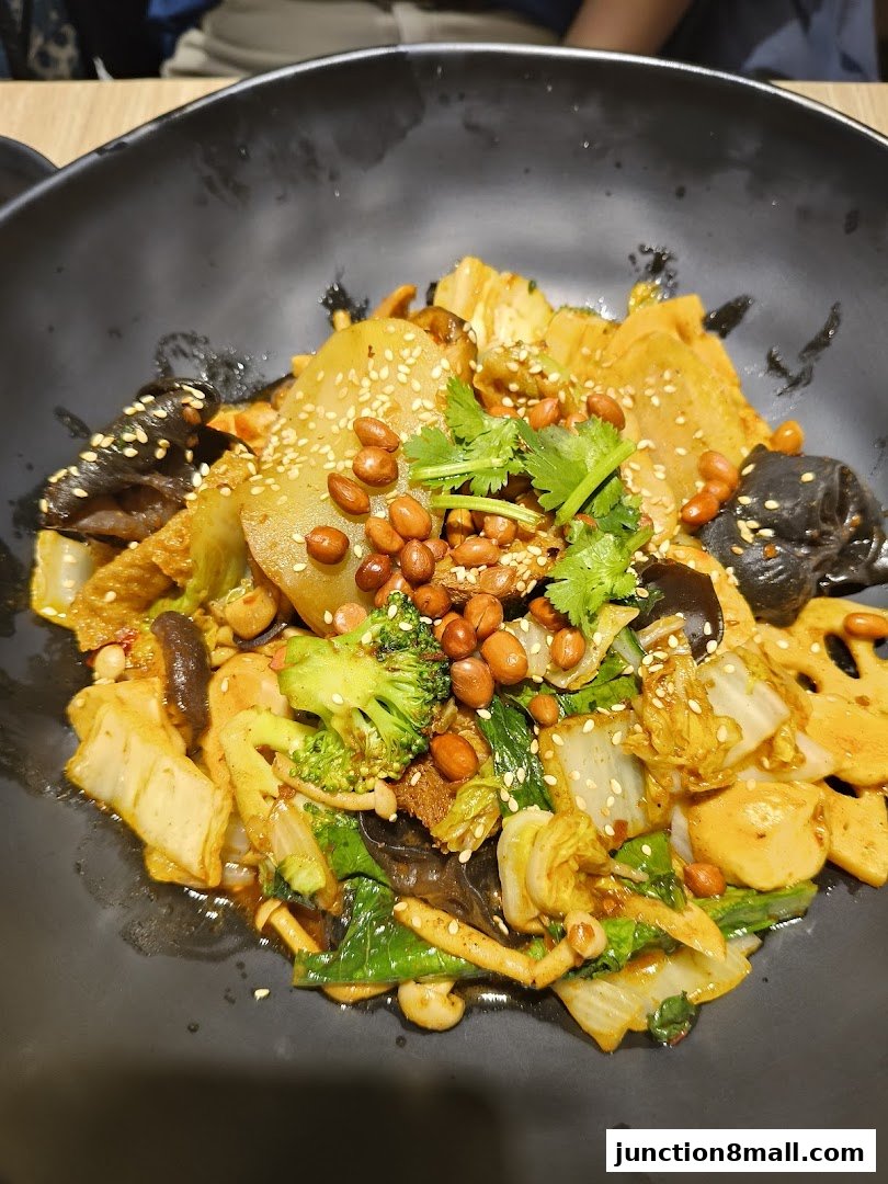 A close-up shot of a flavorful mala xiang guo dish with various vegetables and peanuts.