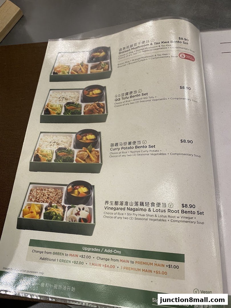 A menu from Greendot Junction 8 showcasing various bento sets with prices and descriptions.