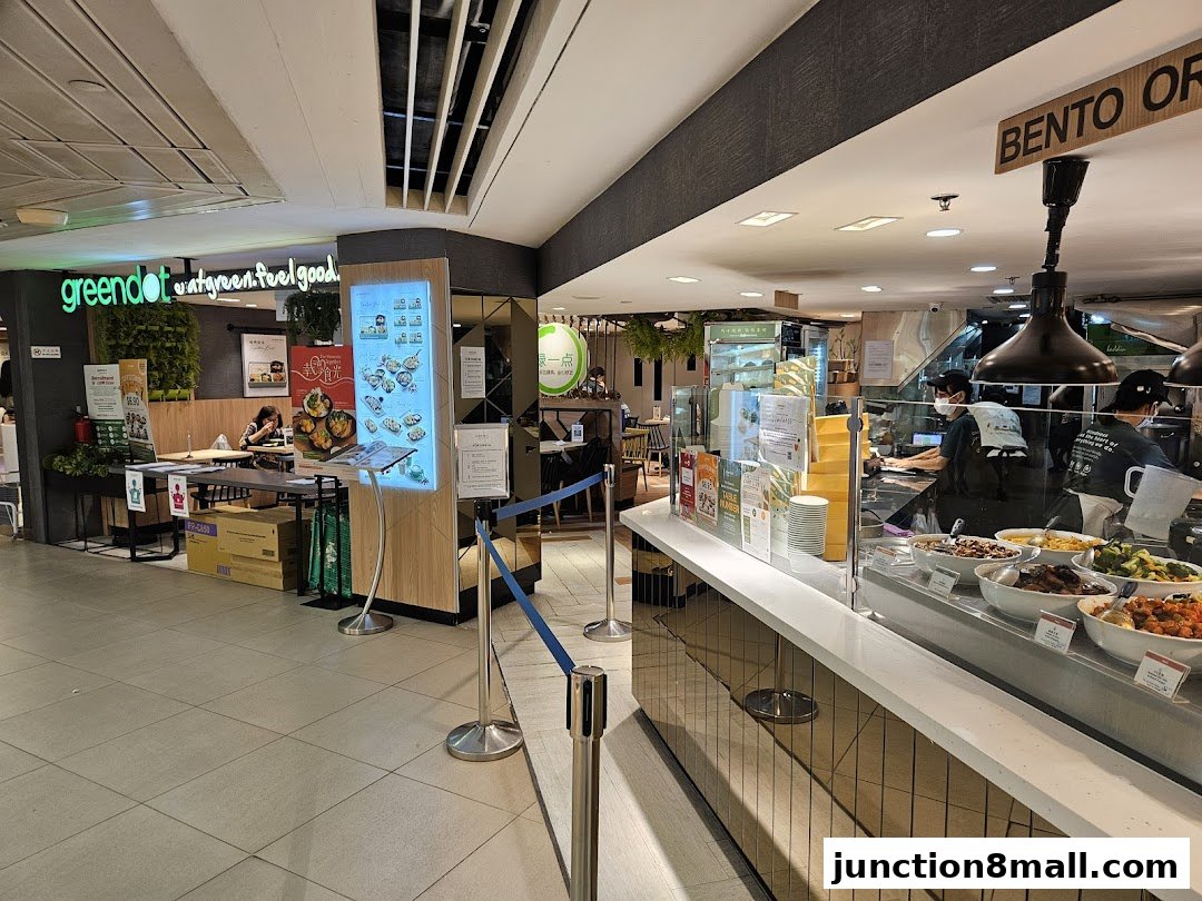A Greendot restaurant interior with a food counter and seating area.