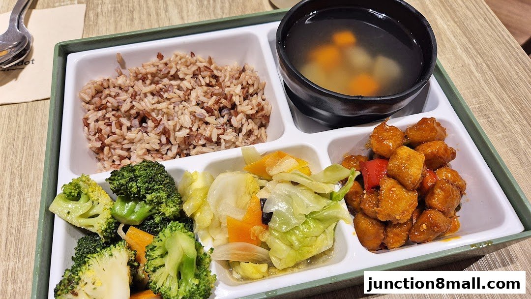 A healthy meal with brown rice, vegetables, soup, and sweet and sour chicken.