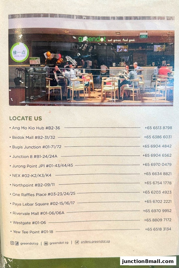A view of the Greendot restaurant interior with customers dining and the store's branding.