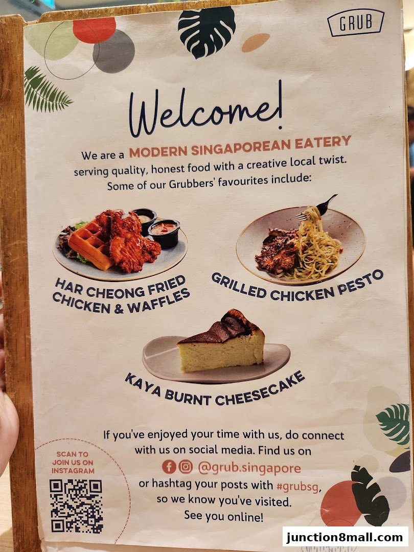 A menu from GRUB Junction 8 showcasing popular dishes like fried chicken and waffles, grilled chicken pesto, and cheesecake.
